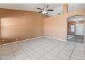 Spacious living room with tile flooring, neutral walls and a ceiling fan at 2541 N 86Th Ave, Phoenix, AZ 85037