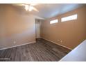 Cozy bedroom with sleek laminate floors, neutral walls, and plenty of natural light at 310 E Payton St, San Tan Valley, AZ 85140
