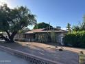 Exterior view of the stone-clad home with cacti and desert landscaping in the front yard at 344 E Aepli Dr, Tempe, AZ 85282