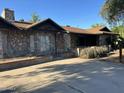 The house has a light rock facade, a brown roof and a long concrete driveway at 344 E Aepli Dr, Tempe, AZ 85282