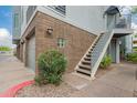 Exterior view showcasing brick facade, stairs to upper unit, and a well-maintained walkway at 3633 N 3Rd Ave # 2031, Phoenix, AZ 85013