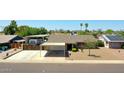 Aerial view showcasing the property's layout with RV parking, desert landscape, and neighborhood at 3802 W Kelton Ln, Phoenix, AZ 85053