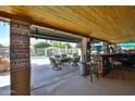 Spacious covered outdoor patio with a bar, lounge area, and backyard swimming pool at 3802 W Kelton Ln, Phoenix, AZ 85053