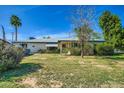 Single-story home with neat landscaping, mature trees, and an inviting facade under a clear blue sky at 3944 E Oak St, Phoenix, AZ 85008