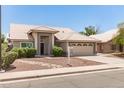 Inviting single-story home with a neutral color scheme and desert-friendly landscaping at 4137 E Stanford Ave, Gilbert, AZ 85234