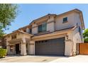 Two-story home featuring a spacious two-car garage, covered entry and neutral color palette at 44517 W Copper Trl, Maricopa, AZ 85139