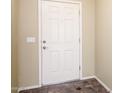 Interior view of a simple front door with neutral walls, a simple peephole, and standard knob at 45391 W Portabello Rd, Maricopa, AZ 85139
