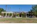 Exterior elevation of the front of the home with green grass and solar panels at 5237 N 106Th Ave, Glendale, AZ 85307