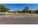 Well maintained front yard with mature trees and green grass at 5237 N 106Th Ave, Glendale, AZ 85307