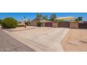 Long driveway leads to a property with desert landscaping, a privacy wall, and an iron gate at 6329 E Voltaire Ave, Scottsdale, AZ 85254