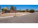 Property on a corner lot with desert landscaping, an iron gate, and a covered parking area at 6329 E Voltaire Ave, Scottsdale, AZ 85254