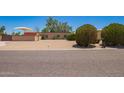 Desert landscaping on a property with a privacy wall, and a covered parking area at 6329 E Voltaire Ave, Scottsdale, AZ 85254