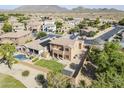 Aerial view of a Southwestern home showcasing a landscaped backyard, pool, and beautiful mountain views at 6922 S Black Hills Way, Chandler, AZ 85249