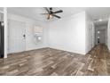 Open living room with durable flooring, a ceiling fan, and a welcoming front door at 701 S Dobson Rd # 447, Mesa, AZ 85202