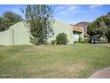 View of the charming single-story home showcasing the yard, landscaping, and roof at 735 E Cochise Dr, Phoenix, AZ 85020