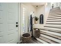 Warm entryway featuring stylish decor, a coat rack, and a staircase at 7400 E Gainey Club Dr # 206, Scottsdale, AZ 85258
