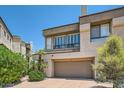 Stylish stucco townhome showcases a private garage and lush, tropical landscaping at 7400 E Gainey Club Dr # 206, Scottsdale, AZ 85258