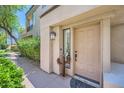 Inviting front entryway featuring a decorative cactus sculpture and stylish door at 7400 E Gainey Club Dr # 206, Scottsdale, AZ 85258