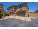 Inviting two-story townhome with a two-car garage and a well-maintained, desert-landscaped front yard at 9534 N 82Nd Ln, Peoria, AZ 85345