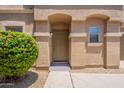 Inviting front door with desert landscaping and a covered entryway for a charming touch at 9534 N 82Nd Ln, Peoria, AZ 85345