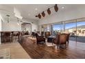 Spacious living room boasts hardwood floors, high ceilings, and large windows with scenic views at 9802 E Hidden Valley Rd, Scottsdale, AZ 85262