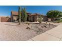 Front yard landscaping with desert plants and decorative stone accents at 10413 E Emelita Ave, Mesa, AZ 85208