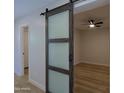 Stylish sliding barn door that adds unique charm to the bedroom at 16447 W Cottonwood St, Surprise, AZ 85388