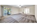 Spacious living area with sliding glass doors leading to a screened patio at 16842 N 103Rd Dr, Sun City, AZ 85351