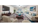 Bright living room with neutral decor, including stylish furniture and large windows at 16842 N 103Rd Dr, Sun City, AZ 85351