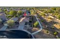 An aerial view of a home in a desert neighborhood, with a walking path along the side of the property at 17416 W Ventura St, Surprise, AZ 85388