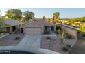 An aerial view of a single-story home with desert landscaping and mature trees at 17416 W Ventura St, Surprise, AZ 85388