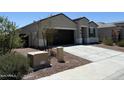 Stylish single-story house featuring a two-car garage and low maintenance desert landscaping at 18765 W Adams St, Buckeye, AZ 85326