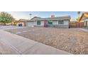 Charming single-story home featuring a spacious front yard with stone landscaping and a two-car garage at 2122 E Radcliffe Dr, Tempe, AZ 85283
