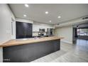Modern kitchen with stainless steel appliances, a large center island, and plenty of cabinet space at 2122 E Radcliffe Dr, Tempe, AZ 85283
