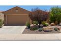 Charming home featuring a neutral color scheme, well-manicured landscaping, and a spacious two-car garage at 21893 N 261St N Ave, Buckeye, AZ 85396