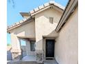 Inviting front entrance with stylish stone accents on columns and a dark-colored front door for contrast at 22523 W Pima St, Buckeye, AZ 85326