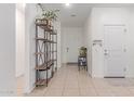 Bright hallway featuring neutral paint, decorative shelving, and a tile floor that flows seamlessly at 37287 N Azteca Rd, San Tan Valley, AZ 85140