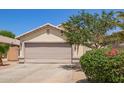 Charming home featuring a two-car garage, well-maintained landscaping, and a welcoming entrance at 3821 N 125Th Dr, Avondale, AZ 85392