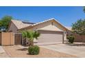 Charming single-story home with desert landscaping, a two-car garage, and solar panels on the roof at 3821 N 125Th Dr, Avondale, AZ 85392