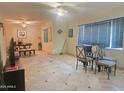 Spacious living room featuring tile floors, neutral walls, and a ceiling fan at 4030 N 33Rd Pl, Phoenix, AZ 85018