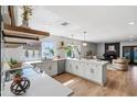 Bright, modern kitchen with white cabinets, stainless appliances, island, and open layout at 4837 E Pershing Ave, Scottsdale, AZ 85254