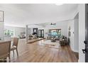 Spacious living room with wood floors, fireplace, and open floor plan to kitchen at 4837 E Pershing Ave, Scottsdale, AZ 85254