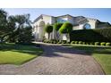 Long, winding driveway leading to a distinguished home, surrounded by manicured landscaping and mature trees at 5610 E Sanna St, Paradise Valley, AZ 85253