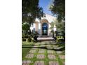 Beautifully landscaped front entrance with a tiled walkway leading to the home's elegant arched entryway at 5610 E Sanna St, Paradise Valley, AZ 85253