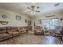 Cozy living room with wood-look flooring, comfortable seating, and natural light at 6154 S Borego Rd, Gold Canyon, AZ 85118