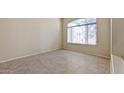 Neutral-toned bedroom featuring tile flooring, base molding and a large window for plenty of natural light at 6923 W Laredo St, Chandler, AZ 85226
