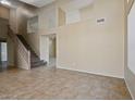 Spacious living room with tile flooring, staircase, neutral colored walls, high ceilings and natural light at 6923 W Laredo St, Chandler, AZ 85226