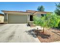 Inviting one-story house with a spacious driveway and well-maintained desert front yard at 8140 W Lane Ave, Glendale, AZ 85303