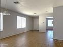 Bright and open living room with tile floors and neutral paint throughout at 8308 W Baxter Dr, Phoenix, AZ 85037