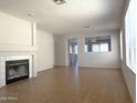 Open-concept living room boasts tile flooring, fireplace, and bright natural light at 8308 W Baxter Dr, Phoenix, AZ 85037